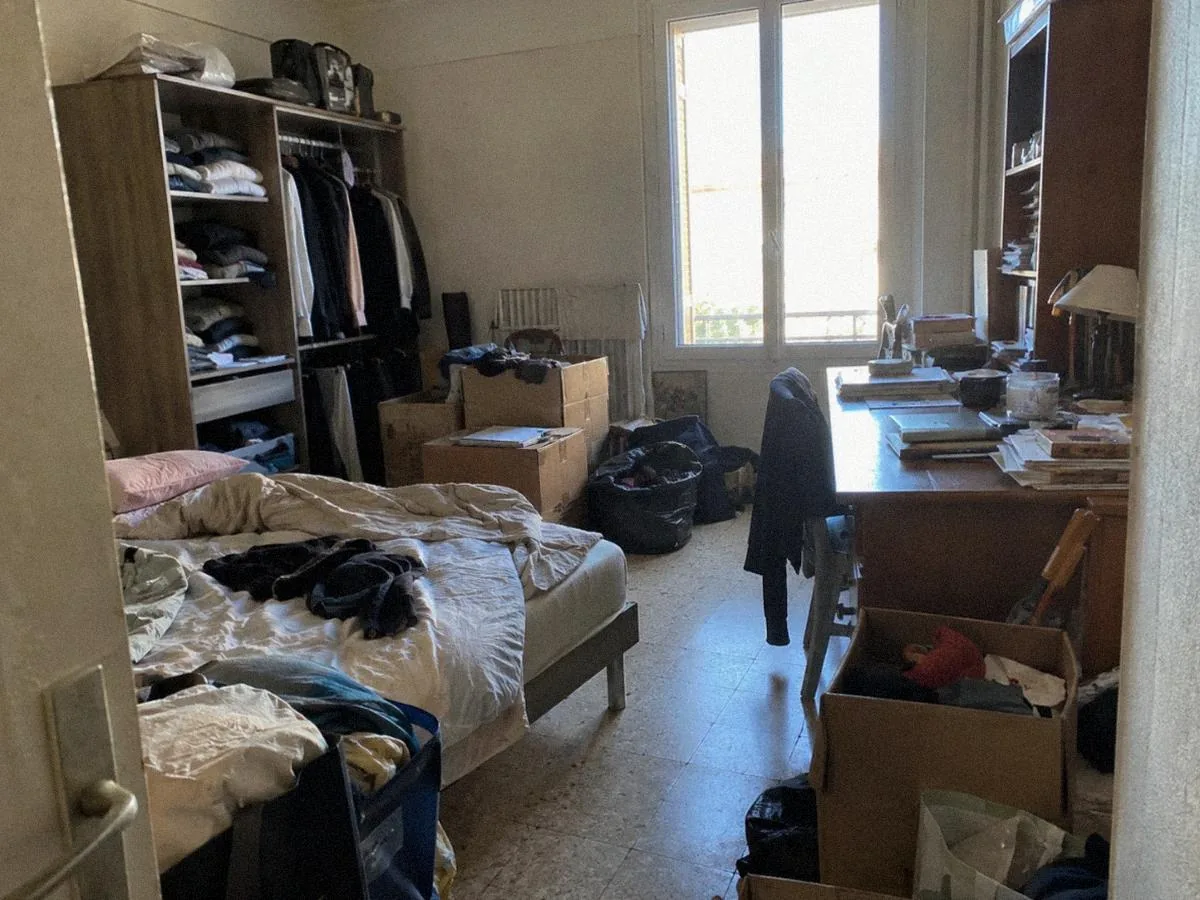 Chambre d'appartement pleine d'affaires, avant le débarras